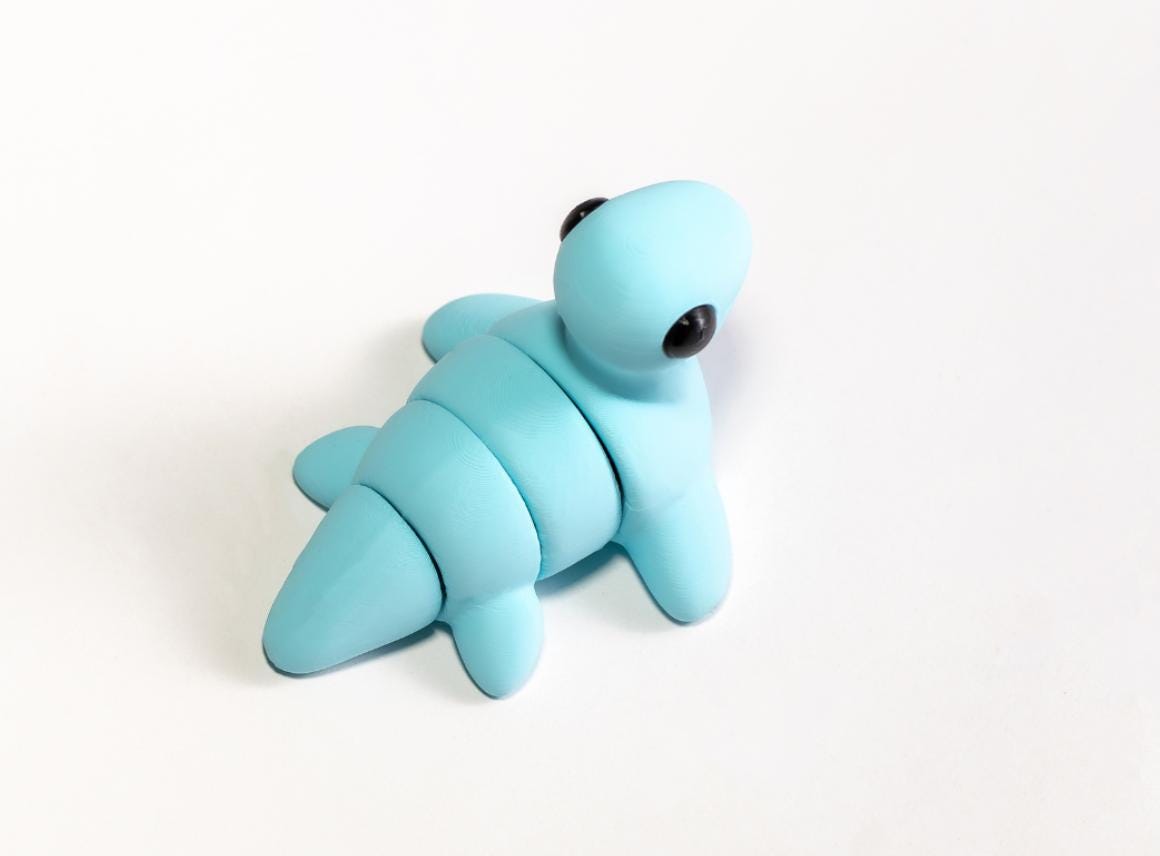 Snuggliez Baby Nessi“  Bewegliches Mini-Nessiewesen & kleiner ADHS-Helfer